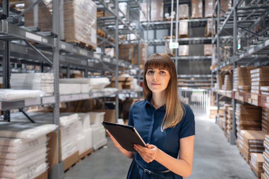 inventory associate standing in a warehouse aisle