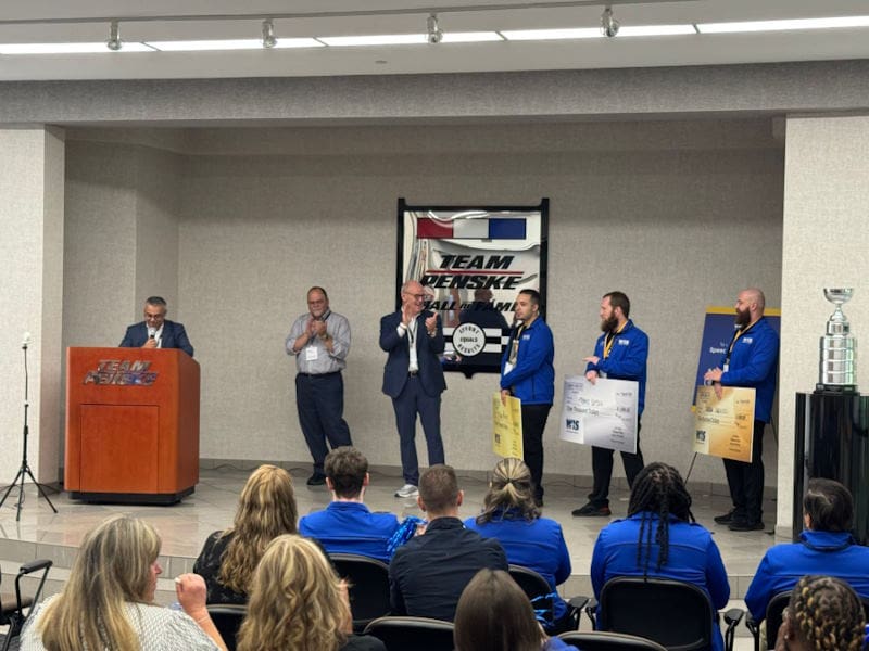 WIS employees on stage presenting donation checks