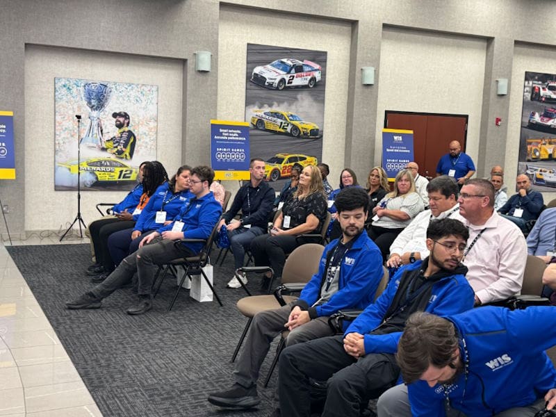 WIS employees listening to a speaker