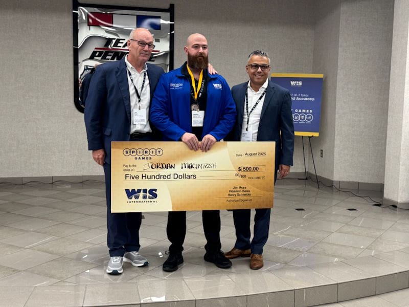 WIS employee standing with donation check 4