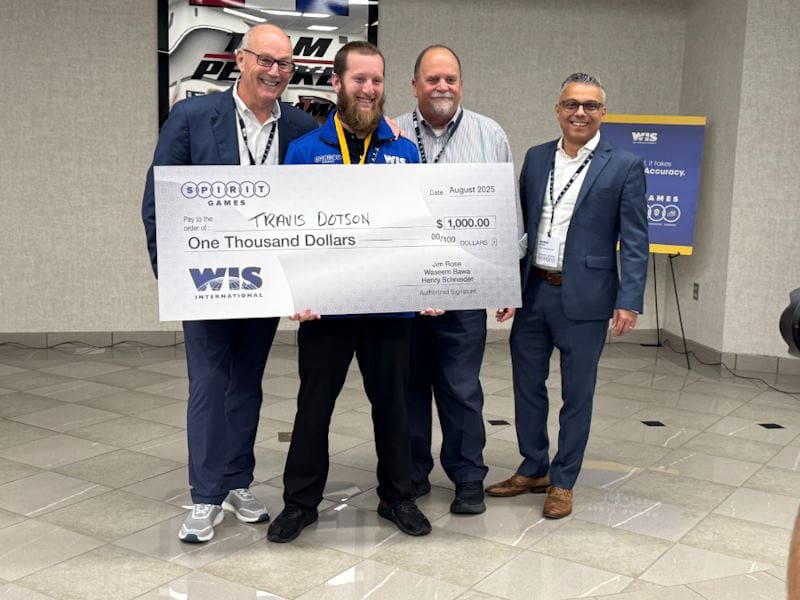 WIS employee standing with donation check 3